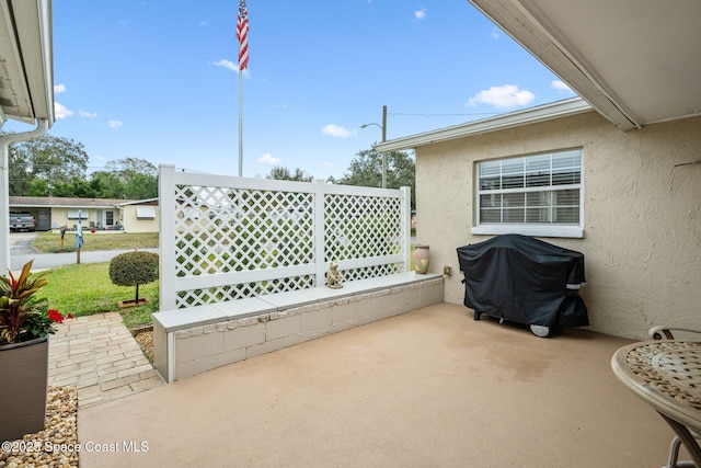 view of patio featuring a grill