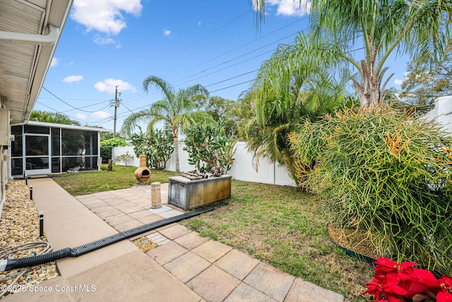 view of yard featuring a patio and a sunroom