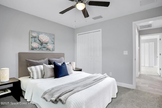 carpeted bedroom featuring a closet and ceiling fan