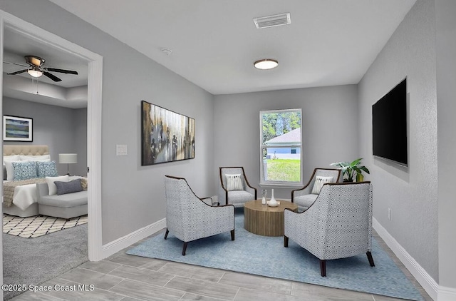 living area with ceiling fan