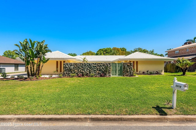 view of front of house featuring a front lawn and stucco siding