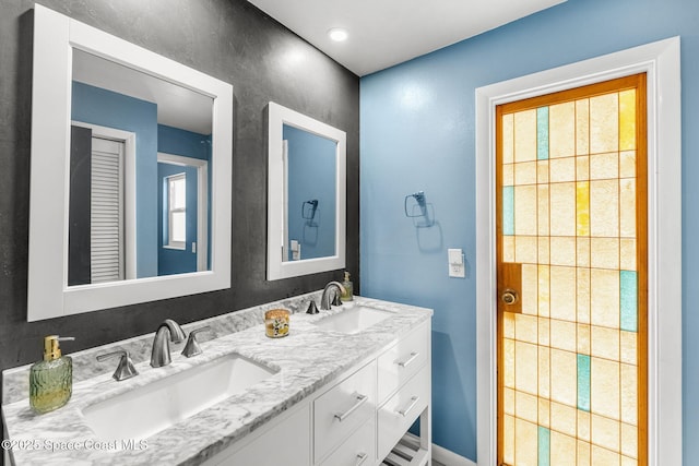 bathroom with double vanity and a sink