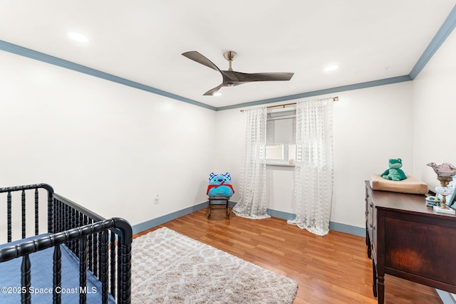 bedroom with light wood finished floors, ceiling fan, baseboards, ornamental molding, and recessed lighting