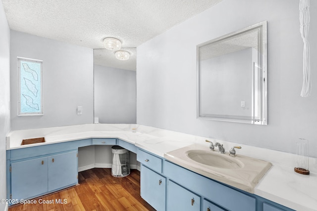 bathroom featuring a textured ceiling, wood finished floors, and vanity