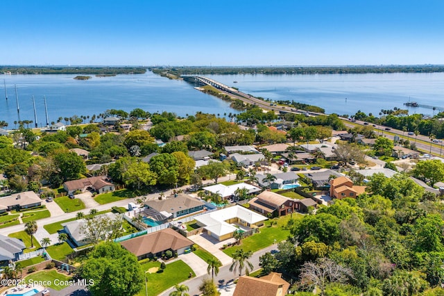 drone / aerial view featuring a residential view and a water view