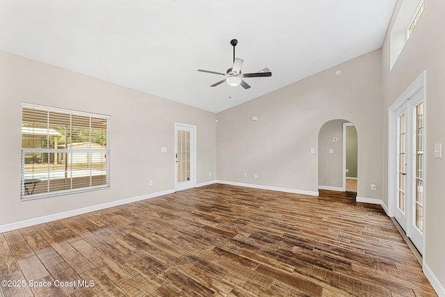 interior space with wood-type flooring, high vaulted ceiling, ceiling fan, and french doors