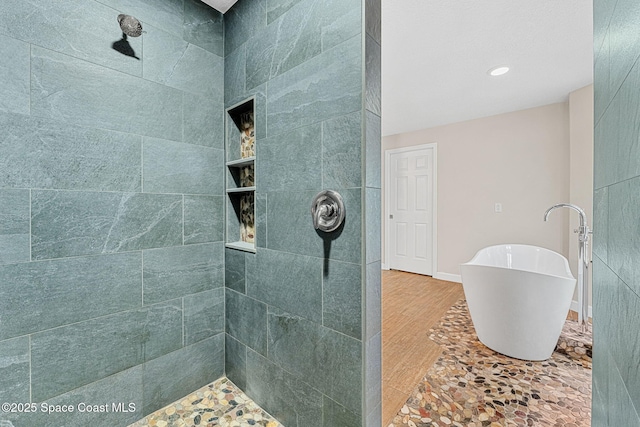 bathroom featuring wood-type flooring and separate shower and tub