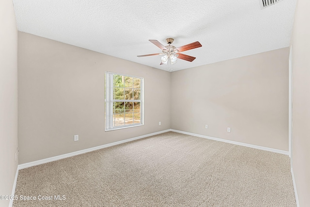 carpeted empty room featuring ceiling fan and a textured ceiling