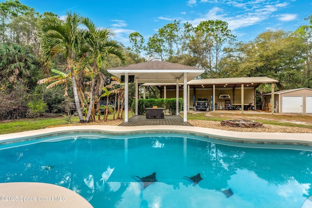 view of swimming pool with an outbuilding, a garage, and a gazebo