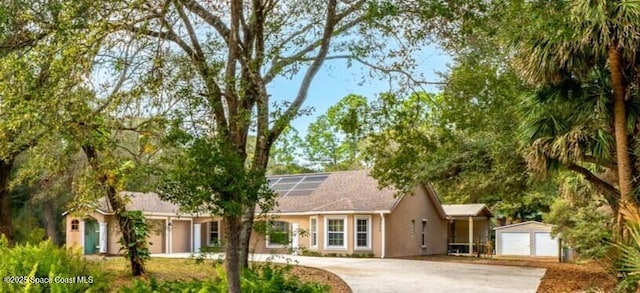 single story home featuring solar panels