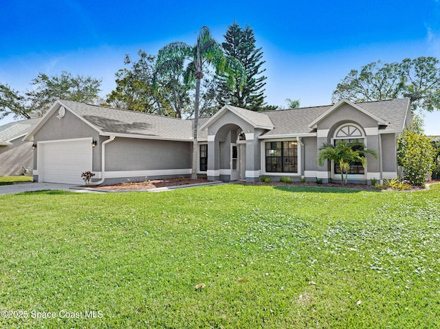 ranch-style house featuring a garage and a front lawn