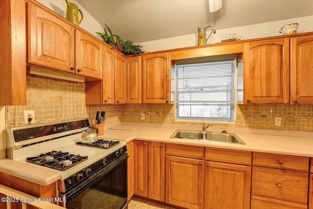 kitchen featuring decorative backsplash, sink, and white range with gas stovetop