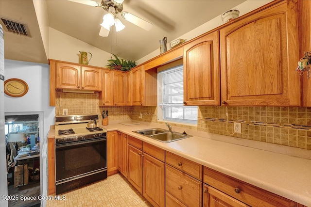 kitchen with vaulted ceiling, sink, decorative backsplash, ceiling fan, and gas range