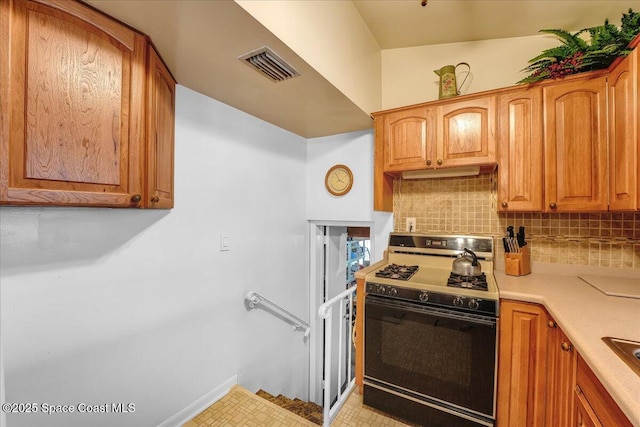 kitchen with tasteful backsplash and range with gas cooktop