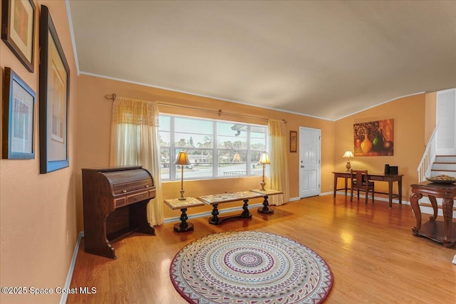 sitting room featuring crown molding, lofted ceiling, and light hardwood / wood-style flooring