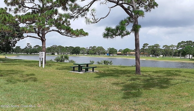 view of home's community featuring a yard and a water view