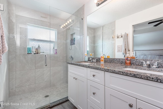 bathroom with vanity and a shower with door