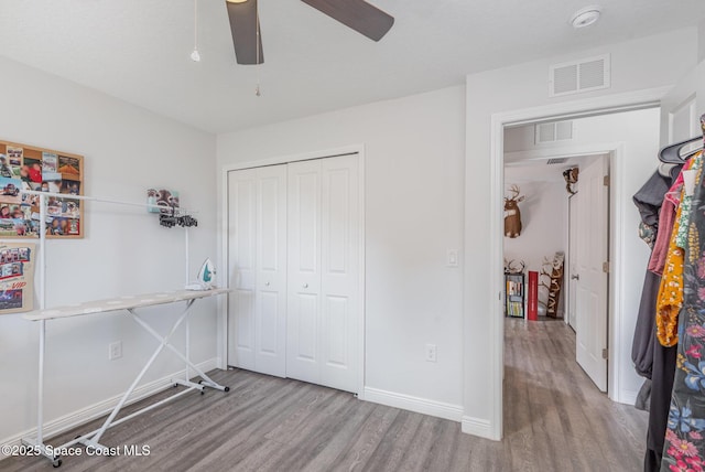 unfurnished bedroom with a closet, ceiling fan, and light wood-type flooring