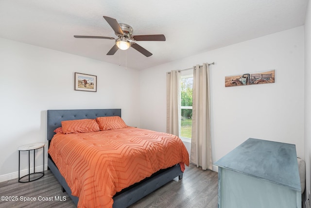 bedroom featuring ceiling fan and dark hardwood / wood-style floors