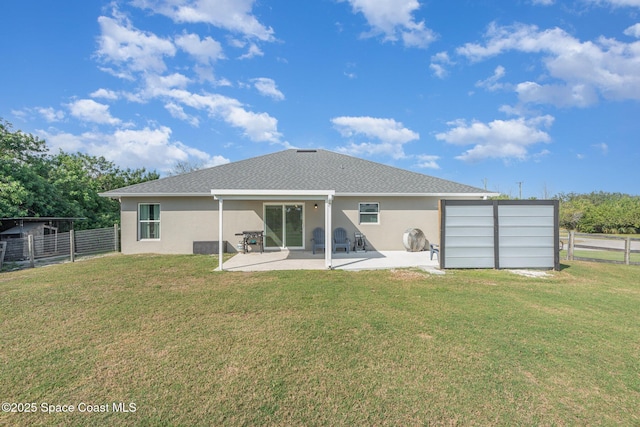 back of property featuring a yard and a patio area