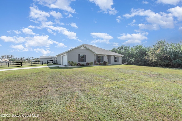 single story home featuring a garage and a front lawn