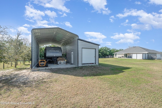 view of outdoor structure featuring a yard and a carport