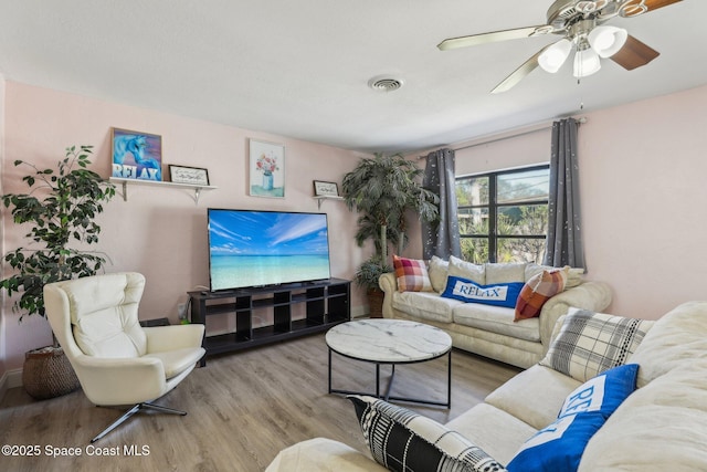 living room with ceiling fan and light hardwood / wood-style floors