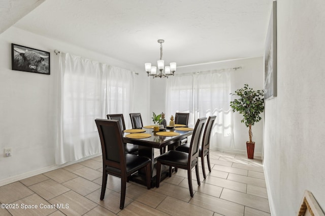 dining area with an inviting chandelier