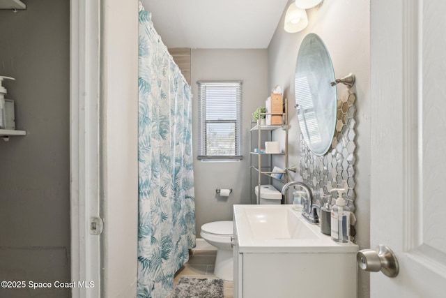 bathroom featuring vanity, tile patterned floors, and toilet