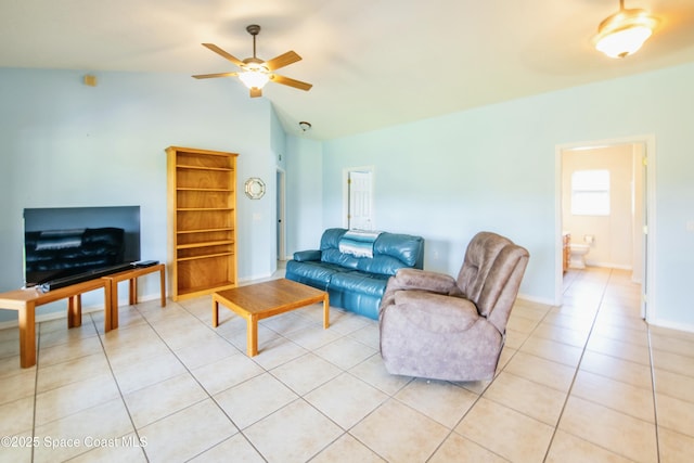 tiled living room with ceiling fan and lofted ceiling