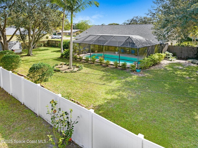 view of yard with a fenced in pool and a lanai