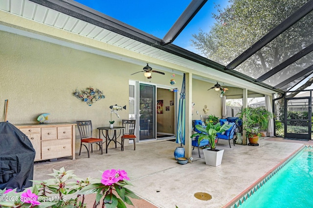 exterior space featuring ceiling fan and glass enclosure