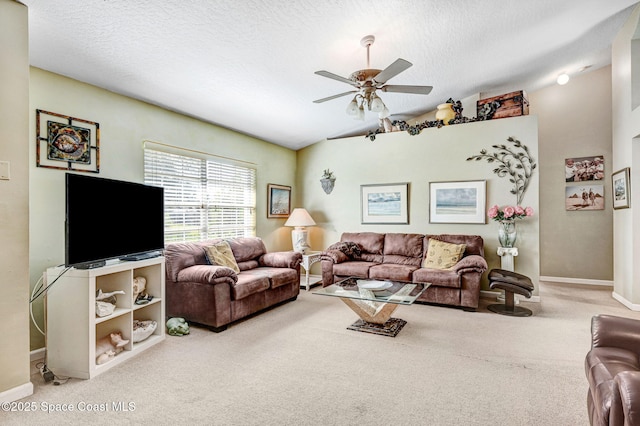 carpeted living room featuring vaulted ceiling, ceiling fan, and a textured ceiling