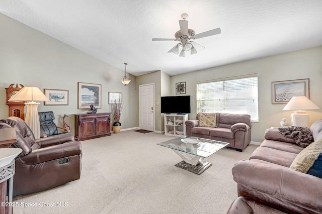 living room featuring ceiling fan, lofted ceiling, light carpet, and a textured ceiling