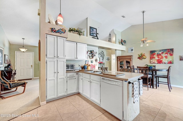 kitchen featuring pendant lighting, white cabinetry, kitchen peninsula, and dishwasher