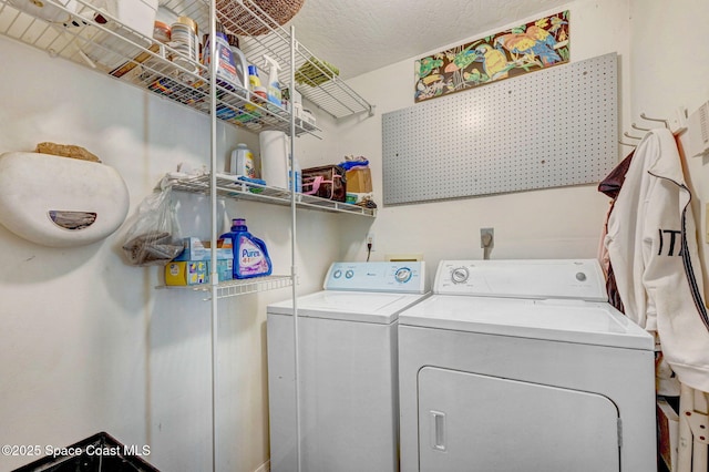 clothes washing area featuring independent washer and dryer and a textured ceiling