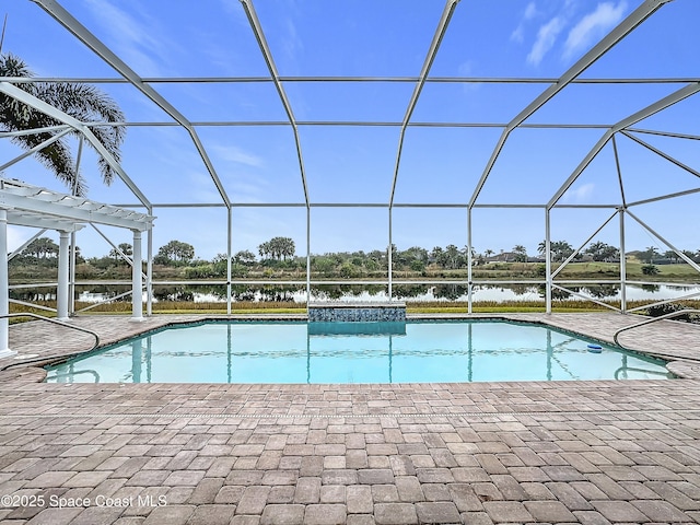 view of pool with a patio area, a water view, and glass enclosure