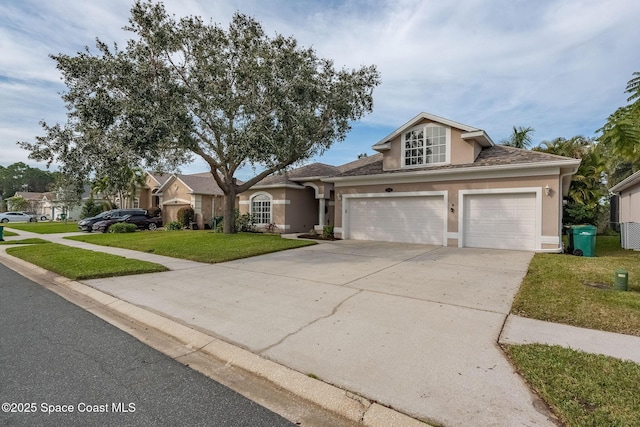 view of front of home featuring a garage and a front yard