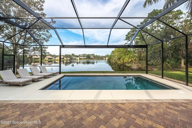 view of pool with a water view, glass enclosure, and a patio area