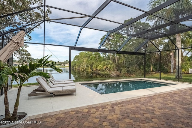 view of pool with a patio, a water view, and glass enclosure