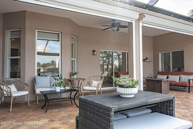 view of patio with outdoor lounge area and ceiling fan