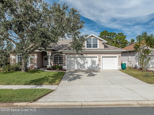 view of front of home with a garage and a front yard