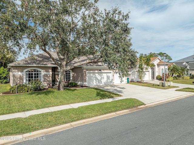 view of front of property with a garage and a front lawn