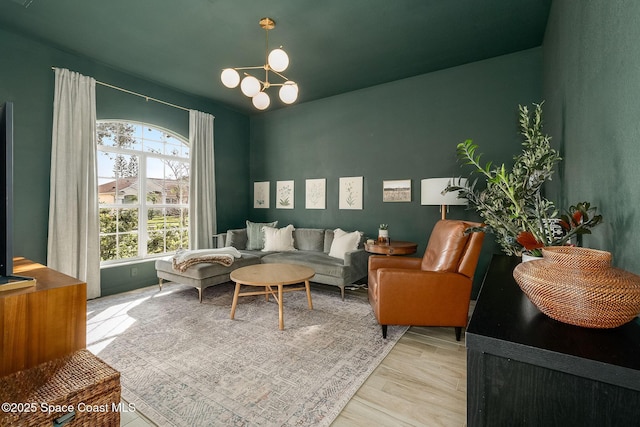 living room featuring light hardwood / wood-style floors and a notable chandelier