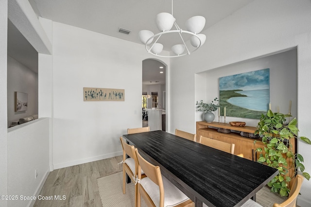 dining room featuring wood-type flooring and a notable chandelier