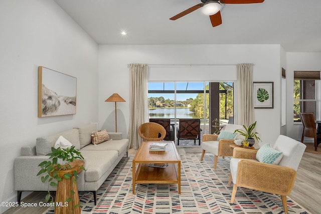 living room featuring light hardwood / wood-style floors and ceiling fan