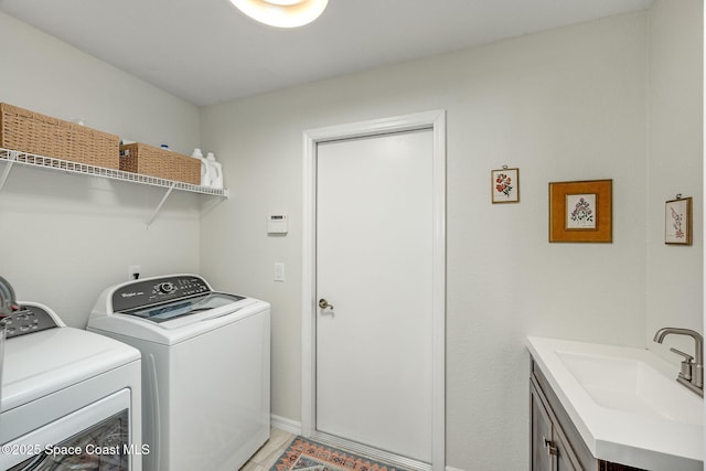 laundry area featuring sink and washing machine and dryer