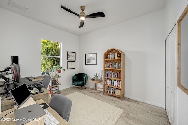 office featuring light hardwood / wood-style floors and ceiling fan