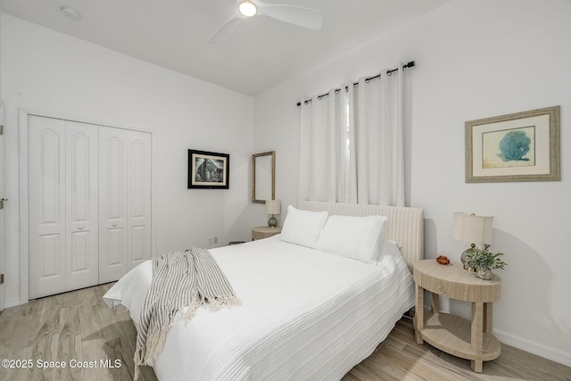 bedroom featuring ceiling fan, a closet, and light wood-type flooring