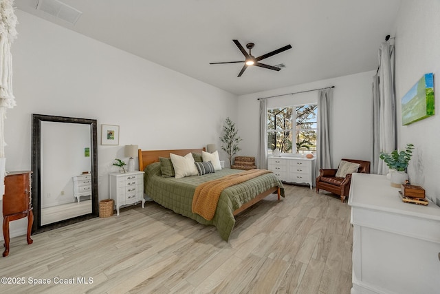 bedroom with light hardwood / wood-style flooring, ceiling fan, and vaulted ceiling